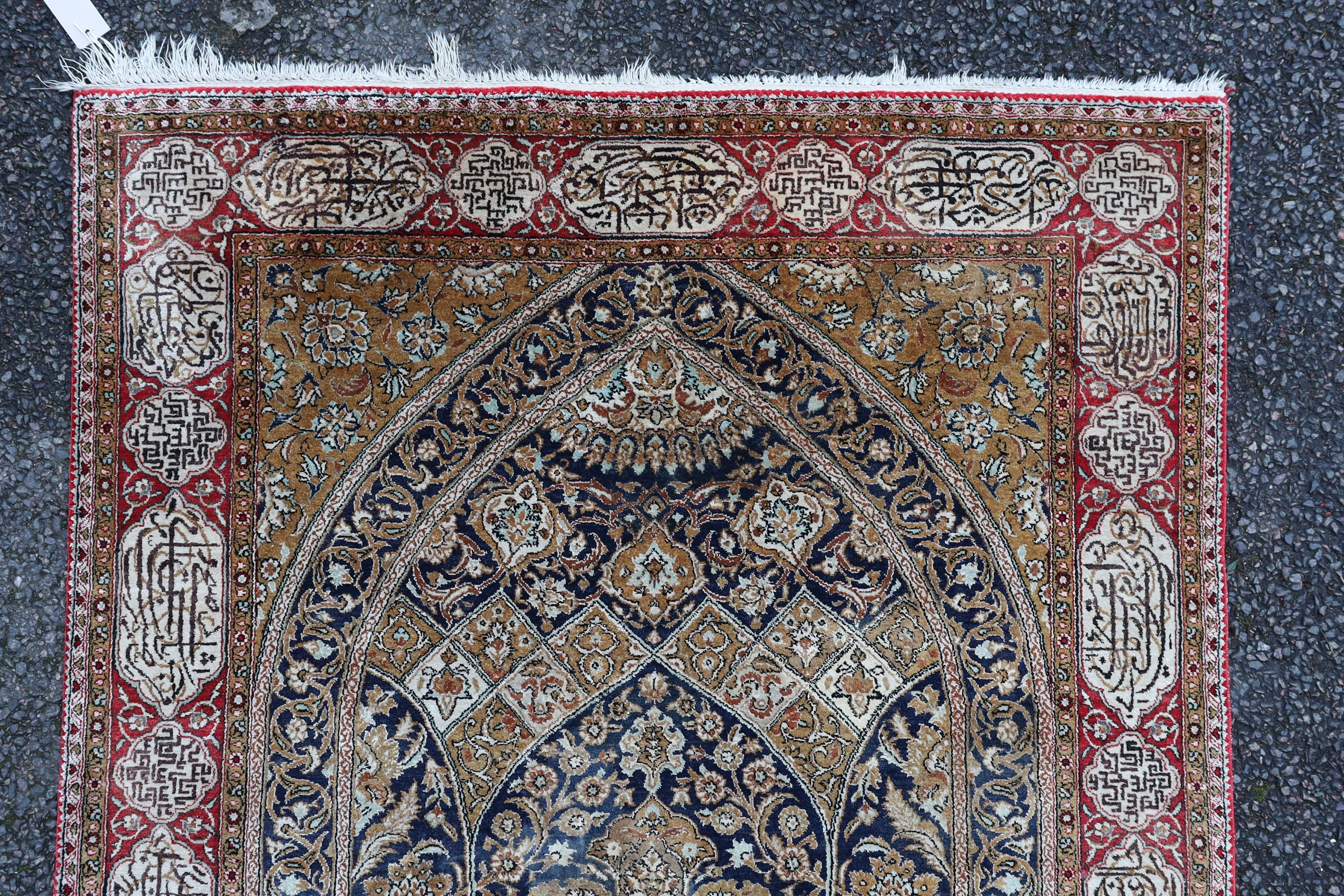 An early 20th century Kashan silk blue ground prayer rug, 162 x 109cm.